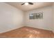 A sunny bedroom featuring wood floors, white walls, and a large window at 6837 E Osborn Rd # F, Scottsdale, AZ 85251