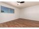 Spacious bedroom featuring hardwood floors, a ceiling fan, and a window providing natural light at 6837 E Osborn Rd # F, Scottsdale, AZ 85251