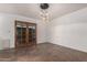 Airy dining area with elegant pendant lighting and a stylish wooden door leading to an outdoor space at 6837 E Osborn Rd # F, Scottsdale, AZ 85251