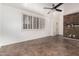 Spacious living room with tile flooring, shutters, a ceiling fan, and an accent wall of stacked stone at 6837 E Osborn Rd # F, Scottsdale, AZ 85251