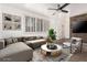 Stylishly staged living room showcasing tile floors, a chic sectional sofa, and a decorative stone accent wall at 6837 E Osborn Rd # F, Scottsdale, AZ 85251