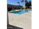 Large community pool with clear water surrounded by lounge seating and palm trees at 6837 E Osborn Rd # F, Scottsdale, AZ 85251