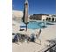 Bright community pool with ample lounge chairs and umbrella-covered tables at 6837 E Osborn Rd # F, Scottsdale, AZ 85251