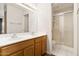 Bathroom with a double vanity and a step-in shower with sliding glass doors at 6920 E 4Th St # 209, Scottsdale, AZ 85251