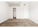 Spacious bedroom with neutral carpet, a closet, and a freshly painted white door at 6920 E 4Th St # 209, Scottsdale, AZ 85251