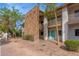 Multi-story condo building with a decorative stone facade and mature landscaping at 6920 E 4Th St # 209, Scottsdale, AZ 85251