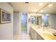 Bright bathroom featuring a double vanity with a large mirror at 7125 N 2Nd Pl, Phoenix, AZ 85020