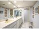 Bright bathroom featuring a double vanity, wallpaper, and tile flooring at 7125 N 2Nd Pl, Phoenix, AZ 85020