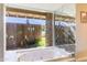 Bathroom features a jacuzzi tub with a view of the backyard and modern accents at 7125 N 2Nd Pl, Phoenix, AZ 85020