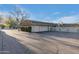 Side view of house highlighting the driveway, garage, and privacy wall at 7125 N 2Nd Pl, Phoenix, AZ 85020