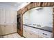 Kitchen area featuring brick arch over cooktop, tile floor, and light cabinets at 7125 N 2Nd Pl, Phoenix, AZ 85020