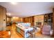 Spacious living room with wood paneling, stone fireplace, and a pool table creating a cozy, recreational atmosphere at 7125 N 2Nd Pl, Phoenix, AZ 85020