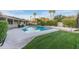 Large pool with lush lawn, palm trees, and well-maintained backyard area at 7125 N 2Nd Pl, Phoenix, AZ 85020