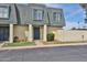 Charming townhouse featuring a gray roof, tan siding, and a secure front door at 8130 N 32Nd Dr, Phoenix, AZ 85051