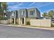 Two-story townhouse featuring a gray roof, tan siding, and well-maintained landscaping at 8130 N 32Nd Dr, Phoenix, AZ 85051