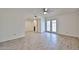 Bright living room with wood-look tile flooring and access to the backyard through glass doors at 8130 N 32Nd Dr, Phoenix, AZ 85051