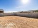 An empty backyard is enclosed by a block wall and has a lot of potential for landscaping and outdoor activities at 8613 W Warner St, Tolleson, AZ 85353