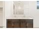 Bathroom vanity featuring double sinks, mirror and cabinets for storage at 8613 W Warner St, Tolleson, AZ 85353