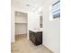 Modern bathroom featuring double sinks, a large mirror and a closet at 8613 W Warner St, Tolleson, AZ 85353