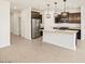 Modern kitchen featuring stainless steel appliances and a large island with quartz countertops at 8613 W Warner St, Tolleson, AZ 85353