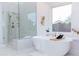 Bright bathroom featuring a soaking tub, walk-in shower, and a window with natural light at 9393 E Hunter Ct, Scottsdale, AZ 85262