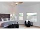 Bright bedroom with a tufted headboard, ceiling fan, and backyard pool view at 9393 E Hunter Ct, Scottsdale, AZ 85262