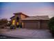 Stunning home exterior with tile roof, arched entryway, and spacious three-car garage at 9393 E Hunter Ct, Scottsdale, AZ 85262