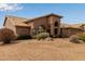 Well-maintained single-story home with desert landscaping and an arched entryway for curb appeal at 9393 E Hunter Ct, Scottsdale, AZ 85262