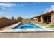 Beautiful pool and spa combination with travertine tile surround, turf accents, and a serene backyard setting at 9393 E Hunter Ct, Scottsdale, AZ 85262