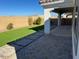 View of the backyard with grass and a patio with pavers at 9804 E Red Giant Dr, Mesa, AZ 85212