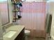 Cozy bathroom featuring modern vanity, open shelving, and decorative shower curtain at 9804 E Red Giant Dr, Mesa, AZ 85212