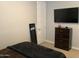 Bedroom with a wall mounted TV and dresser; neutral color palette at 9804 E Red Giant Dr, Mesa, AZ 85212