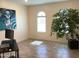 Bright and airy office space with neutral walls, a large potted plant, and a sleek desk at 9804 E Red Giant Dr, Mesa, AZ 85212