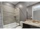 Well-lit bathroom features a shower over tub with gray tile surround and granite countertop vanity at 9932 E Tumbleweed Ave, Mesa, AZ 85212