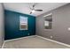 Well-lit bedroom with ceiling fan and two windows offering plenty of natural light at 9932 E Tumbleweed Ave, Mesa, AZ 85212