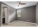 Cozy bedroom featuring neutral carpeting, a ceiling fan, and an en-suite bathroom at 9932 E Tumbleweed Ave, Mesa, AZ 85212