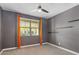 Bedroom with a ceiling fan, window with blinds, and unique wall-mounted shelves at 9932 E Tumbleweed Ave, Mesa, AZ 85212