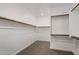 Walk-in closet featuring carpeted floor and multiple shelves and rods for optimal storage at 9932 E Tumbleweed Ave, Mesa, AZ 85212