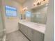 Bright bathroom featuring a double vanity with modern fixtures, a large mirror, and a glass-enclosed shower at 1 Easy St # 11, Carefree, AZ 85377