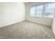 Bright bedroom featuring neutral carpet, a large window with blinds, and neutral decor at 1 Easy St # 11, Carefree, AZ 85377