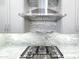 Modern kitchen with stainless steel range hood and stone backsplash at 1 Easy St # 11, Carefree, AZ 85377