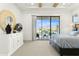 Bright bedroom with a sliding glass door, dresser and outdoor views at 1 Easy St # 11, Carefree, AZ 85377