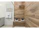 Close-up of modern shower featuring a wood-look tiled wall and built-in bench at 1 Easy St # 11, Carefree, AZ 85377