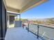 Balcony featuring glass railings with views of a parking lot, surrounding buildings, and mountains at 1 Easy St # 3, Carefree, AZ 85377