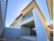 Modern townhouse showcasing clean lines, stucco facade, glass balcony, and private patio with desert landscaping at 1 Easy St # 3, Carefree, AZ 85377