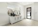 Bright foyer with white walls, modern cabinet, three circular mirrors, and tiled floor at 1 Easy St # 3, Carefree, AZ 85377