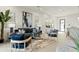 Modern living room with stylish furniture, a neutral rug, a decorative mirror, and a view into the dining area at 1 Easy St # 3, Carefree, AZ 85377