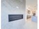 Modern fireplace wall with tiled herringbone pattern adjacent to a kitchen area at 1 Easy St # 3, Carefree, AZ 85377