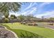 A beautiful putting green surrounded by lush landscaping and framed by a picturesque mountain backdrop at 1 Easy St # 3, Carefree, AZ 85377