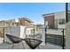 Relaxing balcony featuring modern chairs, glass railings, and a view of nearby homes at 1 Easy St # 6, Carefree, AZ 85377